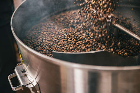 Close up of coffee beans in coffee roasting machine in a small manufacturing