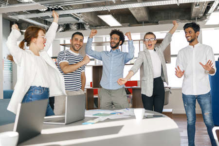 Diverse group of colleagues enjoying working together in an office. Teamwork concept
