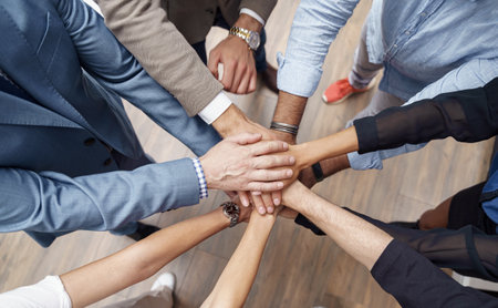 Top view of group coworkers stacked hands together as concept of corporate unity