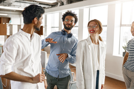 Diverse group of colleagues enjoying working together in an office. Teamwork concept