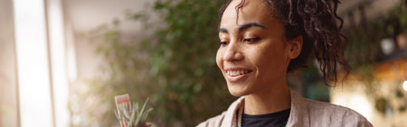 Woman florist takes care of seedlings in floral studio. Gardening concept. Blurred background