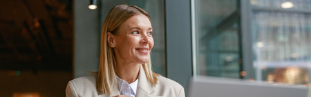 Smiling businesswoman having coffee break time during working day in cafe and looking at window