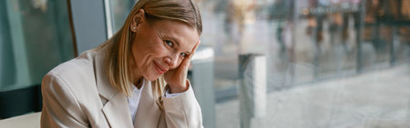 Smiling businesswoman having lunch and making notes while working in cafeの写真素材