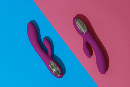 Two violet dildo vibrators on colored background. Sex toy for adult. Sex shop conceptの写真素材