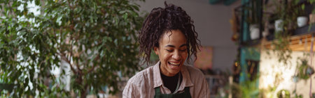 Happy smiling woman florist making succulent plant composition at floral design studio