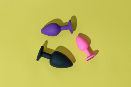 Different colored buttplug sex toys with contrast shadows. Anal toys for adult. Sex shop conceptの写真素材