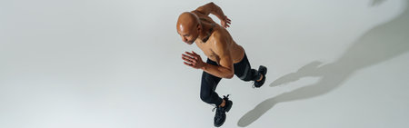 Top view of Professional male athlete running isolated on white studio background with shadows