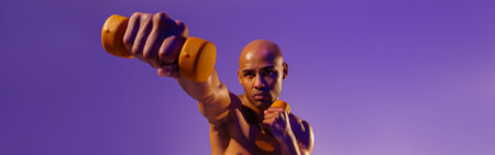 Muscular man doing exercise with weight dumbbells on studio background. Strength and motivation