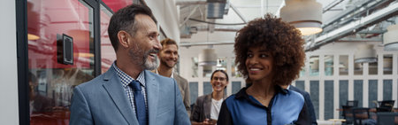 Two business people talking while standing in office during break. Teamwork conceptの写真素材