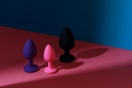 Different colored buttplug sex toy with contrast shadows. Anal toys for adult. Sex shop conceptの写真素材