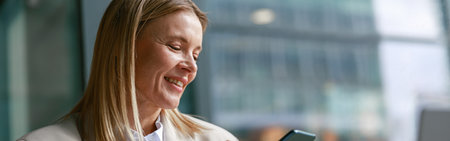 Cheerful businesswoman in jacket use phone during working in cafe. Distance work concept