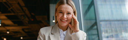 Smiling businesswoman drinking coffee and making notes while working in cafe