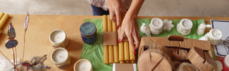 Close up of woman is packing handmade candles for selling in own home decor studioの写真素材