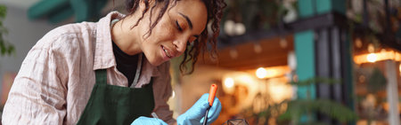 Professional smiling woman florist making succulent plant composition at floral design studioの写真素材