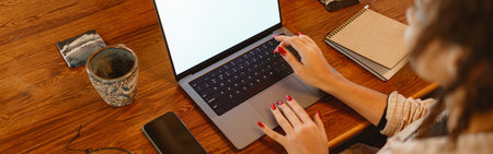 Close up of woman freelancer working on laptop on his workplace at home
