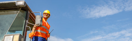Multiracial construction worker using heavy machinery in plant
