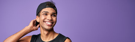 Happy young transgender man smile portrait. Cheerful latino male in black t-shirt. Purple background