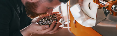 Close up of barista inhaling the aroma of coffee beans in own manufacturing. Blurred backgroundの写真素材