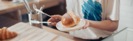 Female hand holding plate with delicious pastryの写真素材