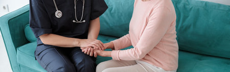 Adult pediatrician visiting old woman at home