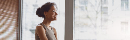 Woman taking online yoga class from home. Female engaged in webcam meditation practice on computerの写真素材