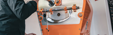 Professional barista operating modern coffee bean roasting machineの写真素材