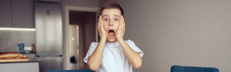 Funny scared small boy expressing shocked emotions about lessons. Scary homework.の写真素材