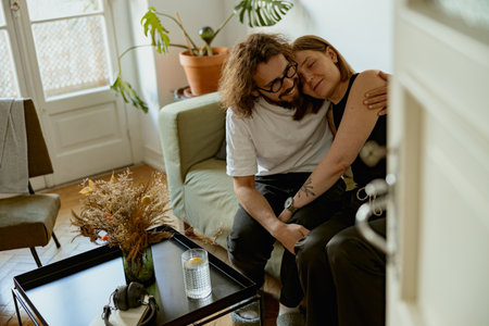 Man and woman hugging and enjoying time together in living room at home. Good relationship timeの写真素材