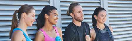 Young mixed race sportive people holding fitness equipment
