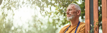 Middle aged caucasian farmer standing near fenceの写真素材