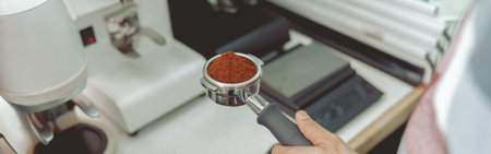 Barista standing near the workplace holding filter in his handsの写真素材