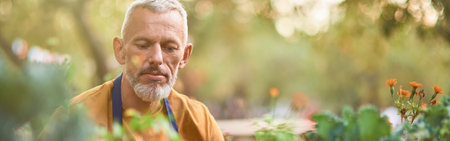 Middle aged caucasian man working with gardening toolの写真素材