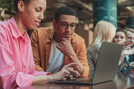 Group of coworkers working together and talking at modern office. Workplace and cooperation conceptの写真素材
