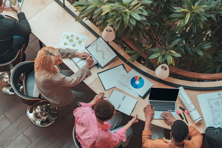 Group of coworkers working together and talking at modern office. Workplace and cooperation conceptの写真素材