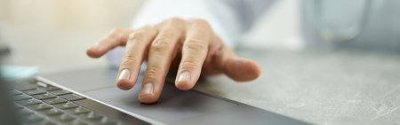 Male doctor hand using modern laptop in clinicの写真素材