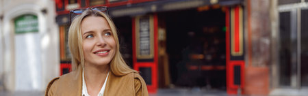 Portrait of dreaming woman sitting outdoors near restaurant