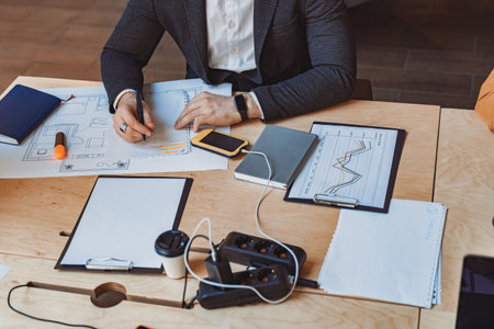 Close up of male architect engineer making notes during work with a construction project