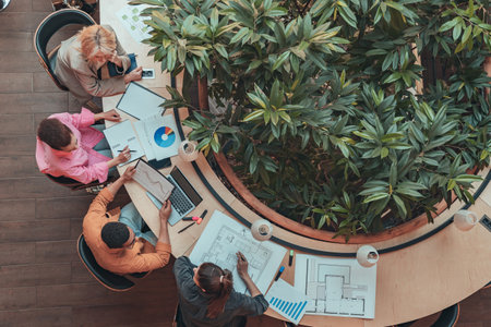 Top view of group of coworkers working together and talking at modern office. Cooperation conceptの写真素材