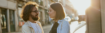 Smiling romantic couple in love holding hands while standing on old city european street on sunset