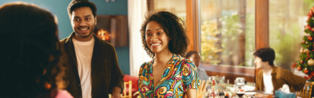 Happy friends enjoying in conversation during festive dinner at home partyの写真素材