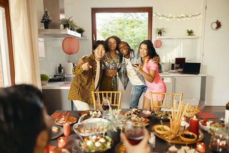 Group of young smiling friends having party and dancing at home. Friendship life style conceptの写真素材