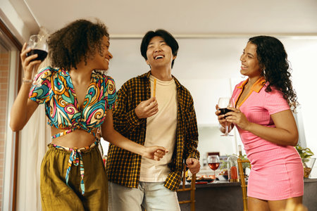 Group of young smiling friends having party and dancing at home. Friendship life style conceptの写真素材