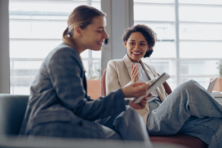 Woman office worker discussing new project with colleague during working day in coworkingの写真素材