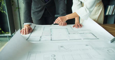 Businesspeople analyzing architectural drawings. Close up.の写真素材