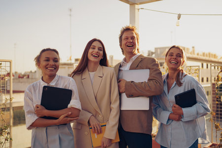 A Group of Happy Professionals Smiling Together Outdoors in an Urban Environmentの写真素材