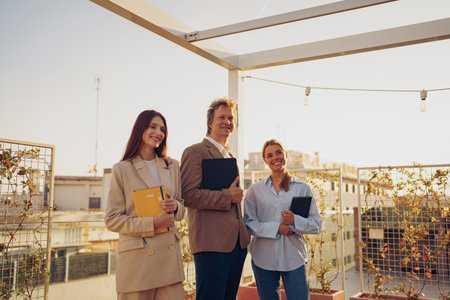 A Professional Team Collaboration is taking place on a rooftop setting with Notebooks presentの写真素材