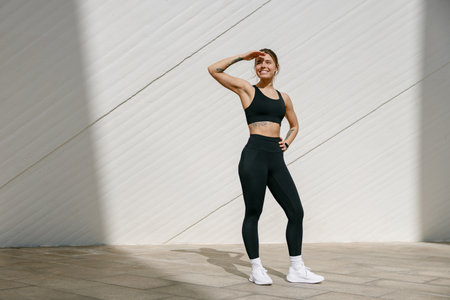 Young female athlete in sportswear looks awayの写真素材