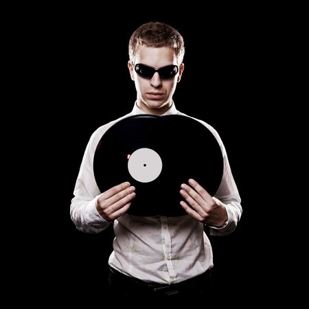 portrait of handsome dj with vinyls over black backgroundの写真素材