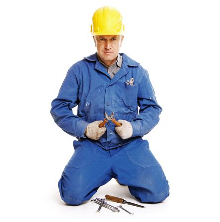 handsome workman sitting against white backgroundの写真素材