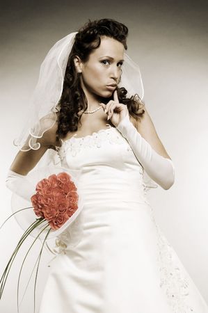 charming bride with roses over grey backgroundの写真素材